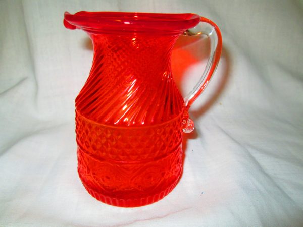 Beautiful Orange Miniature Glass Pitcher Diammond pattern center swirl top and patterned bottom clear handle