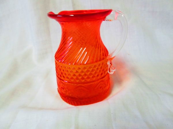 Beautiful Orange Miniature Glass Pitcher Diammond pattern center swirl top and patterned bottom clear handle