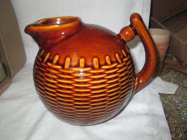 Really neat basket weave pattern round ball pottery pitcher Brown glazed with ice catcher