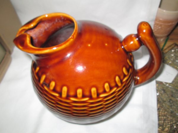 Really neat basket weave pattern round ball pottery pitcher Brown glazed with ice catcher