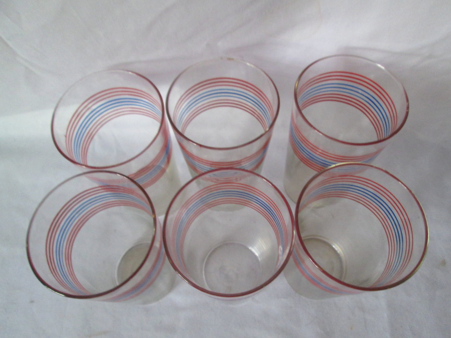 https://www.truevintageantiques.com/wp-content/uploads/2017/06/vintage-1950s-horizontal-striped-red-and-blue-on-clear-glass-tumblers-water-glasses-set-of-6-iced-tea-large-tumblers-59497ad82.jpg