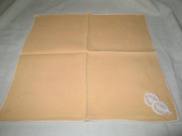 Pretty Pale Orange color handkerchief with small white applique circles and whtie trimmed edge