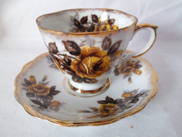Vintage Tea cup and saucer Yellow flowers gray leaves gold trim Beautiful pattern Unmarked