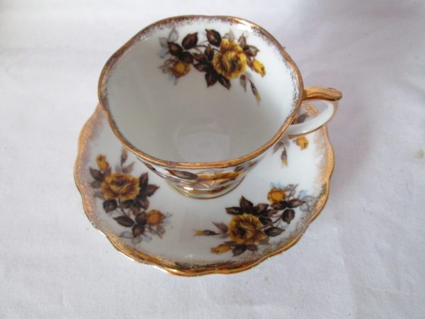 Vintage Tea cup and saucer Yellow flowers gray leaves gold trim Beautiful pattern Unmarked