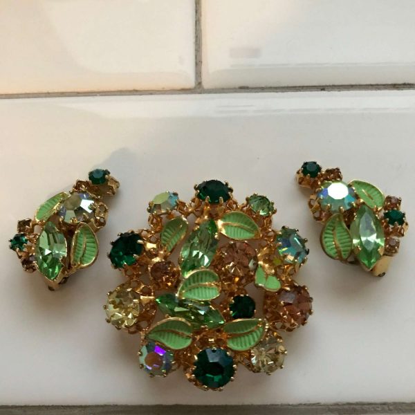 Antique Austrian Crystal brooch with matching clip earrings green gold  blue enameled green leaves Marked made in Austria 1920's