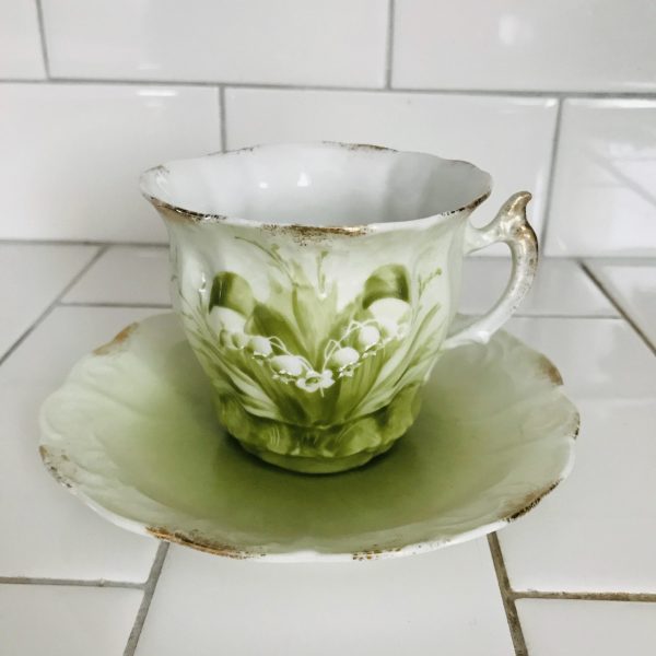 Antique Tea cup and saucer Hand painted enameled Lily of the Valley Green background Fine bone china gold trim farmhouse collectible display