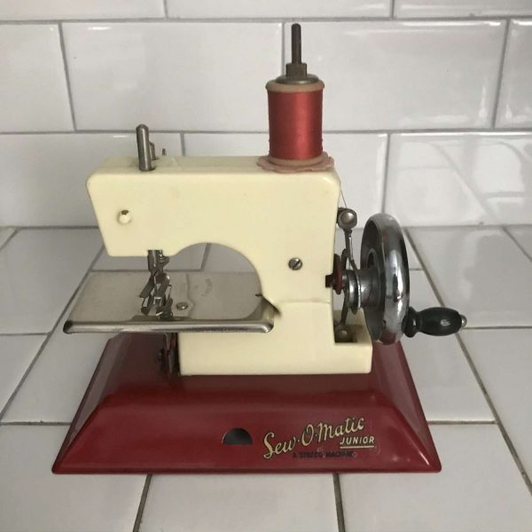 Child size Straco Sew-O-Matic Junior Red and Ivory sewing machine hand crank England Metal 1940's collectible display