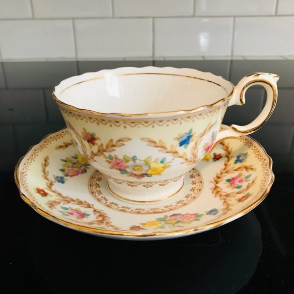 Crown Staffordshire tea cup and saucer England Fine bone china Light Yellow pink yellow blue flowers gold trim farmhouse collectible display