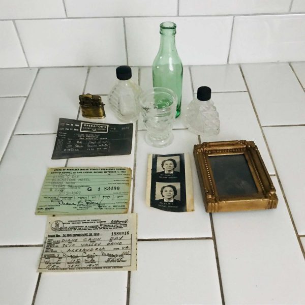 Lot of collectibles trinkets paperwork tin type green bottle 2 perfume bottles glass cup brass lighter re-sellers lot or bed and breakfast