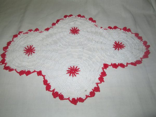 Pretty white hand made doily red trim and centers