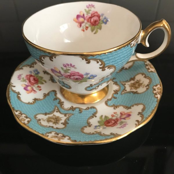 Queen Anne tea cup and saucer England Fine bone china Pink Yellow Blue bouquet Aqua background farmhouse collectible display coffee