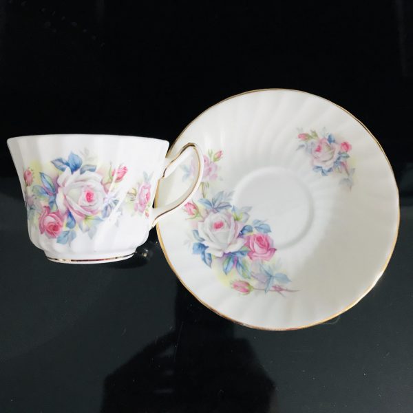 Tea cup and saucer England Fine bone china Pink White Roses blue green leaves gold trim farmhouse collectible display cottage coffee