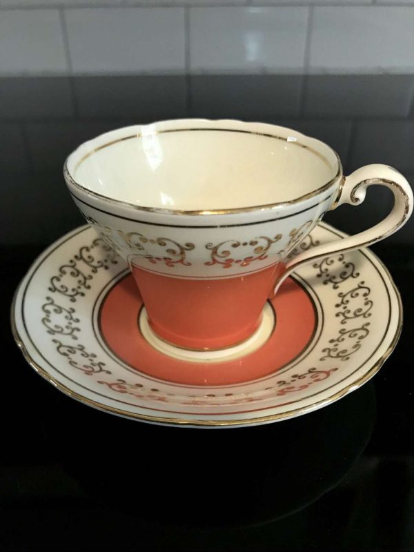 Vintage Aynsley Demitasse Corset Shape Tea cup and saucer Dark Peach with gold trim ivory background collectible display