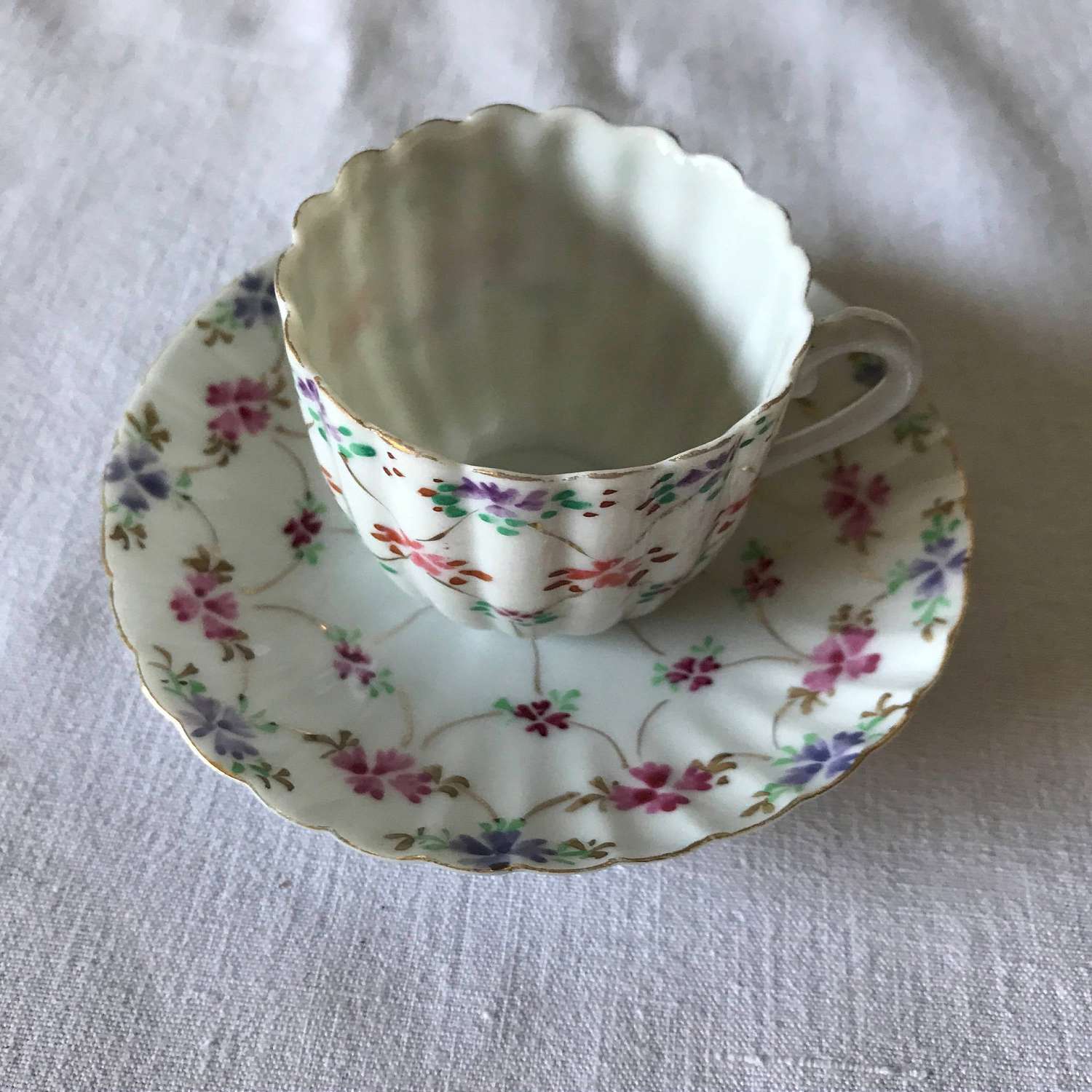 https://www.truevintageantiques.com/wp-content/uploads/2019/12/vintage-fine-bone-china-demitasse-tea-cup-and-saucer-ribbed-pattern-china-tiny-flowers-pink-purple-orange-japan-collectible-display-5df019c92-scaled.jpg