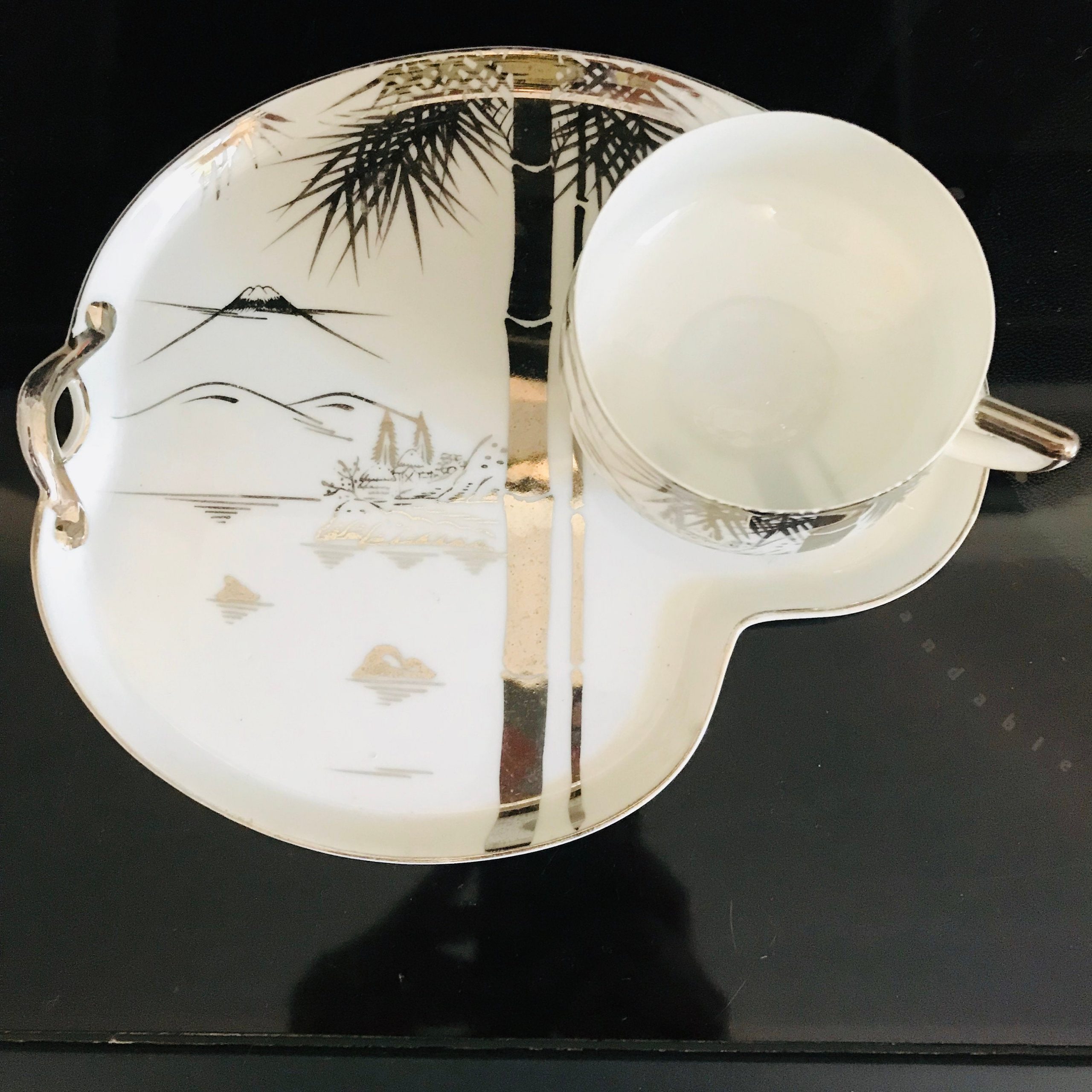 https://www.truevintageantiques.com/wp-content/uploads/2019/12/vintage-hakusan-japan-tea-cup-and-saucer-snack-plate-fine-bone-china-white-with-silver-asian-scene-farmhouse-collectible-display-cottage-5e0559bf6-scaled.jpg