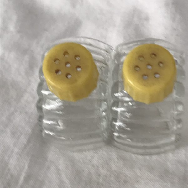 Vintage individual 2 Salt Shakers Glass with celluloid yellow colored lids Retro Kitchen collectible display farmhouse cottage cabin tilt