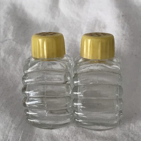 Vintage individual 2 Salt Shakers Glass with celluloid yellow colored lids Retro Kitchen collectible display farmhouse cottage cabin tilt