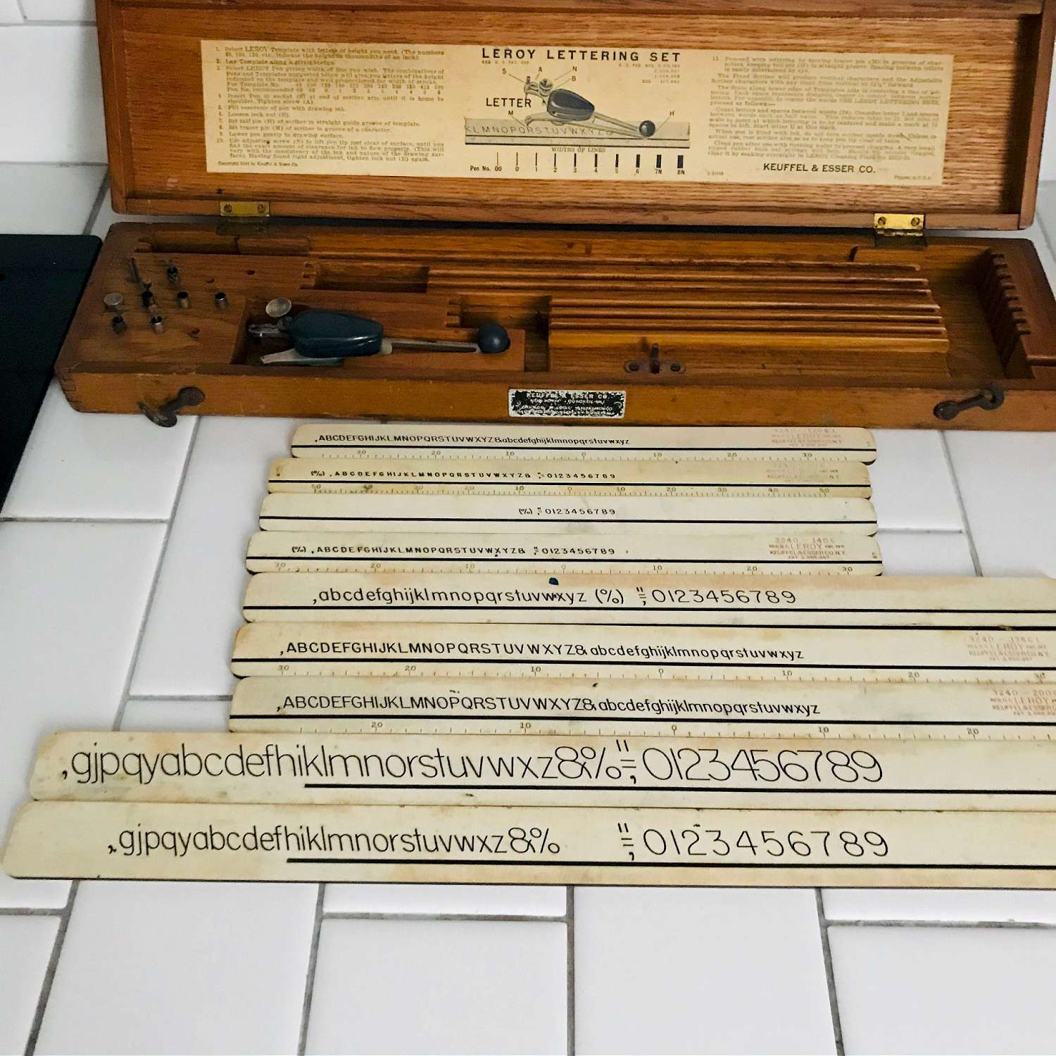https://www.truevintageantiques.com/wp-content/uploads/2019/12/vintage-lettering-kit-leroy-lettering-set-keuffel-esser-new-york-1944-template-farmhouse-office-collectible-display-5df1190e7-scaled.jpg