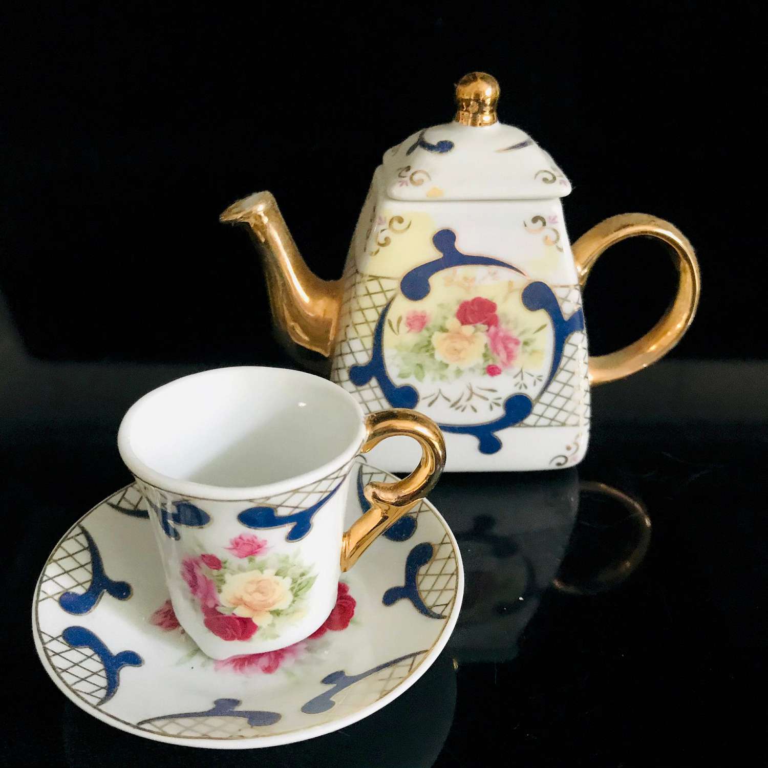 https://www.truevintageantiques.com/wp-content/uploads/2019/12/vintage-miniature-tea-set-imperial-china-blue-gold-trim-with-yellow-pink-dark-pink-roses-heavy-gold-collectible-display-farmhouse-cottage-5df06aea2-scaled.jpg