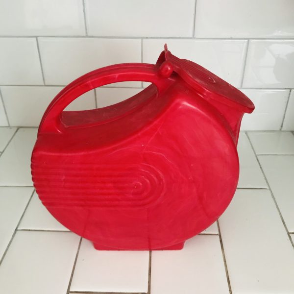 Vintage red plastic disc pitcher lidded with ribbed pattern swirl white in plastic farmhouse retro kitchen collectible display 1950's