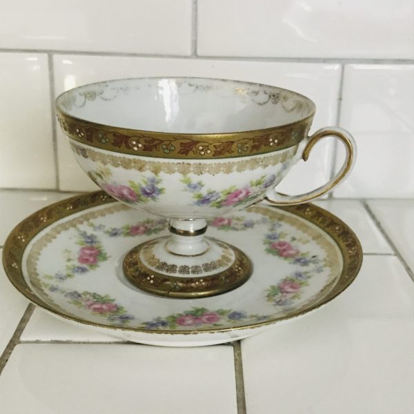 Antique Pedestal Tea cup and saucer Austria Orante detail Rose swags and heavy gold trim
