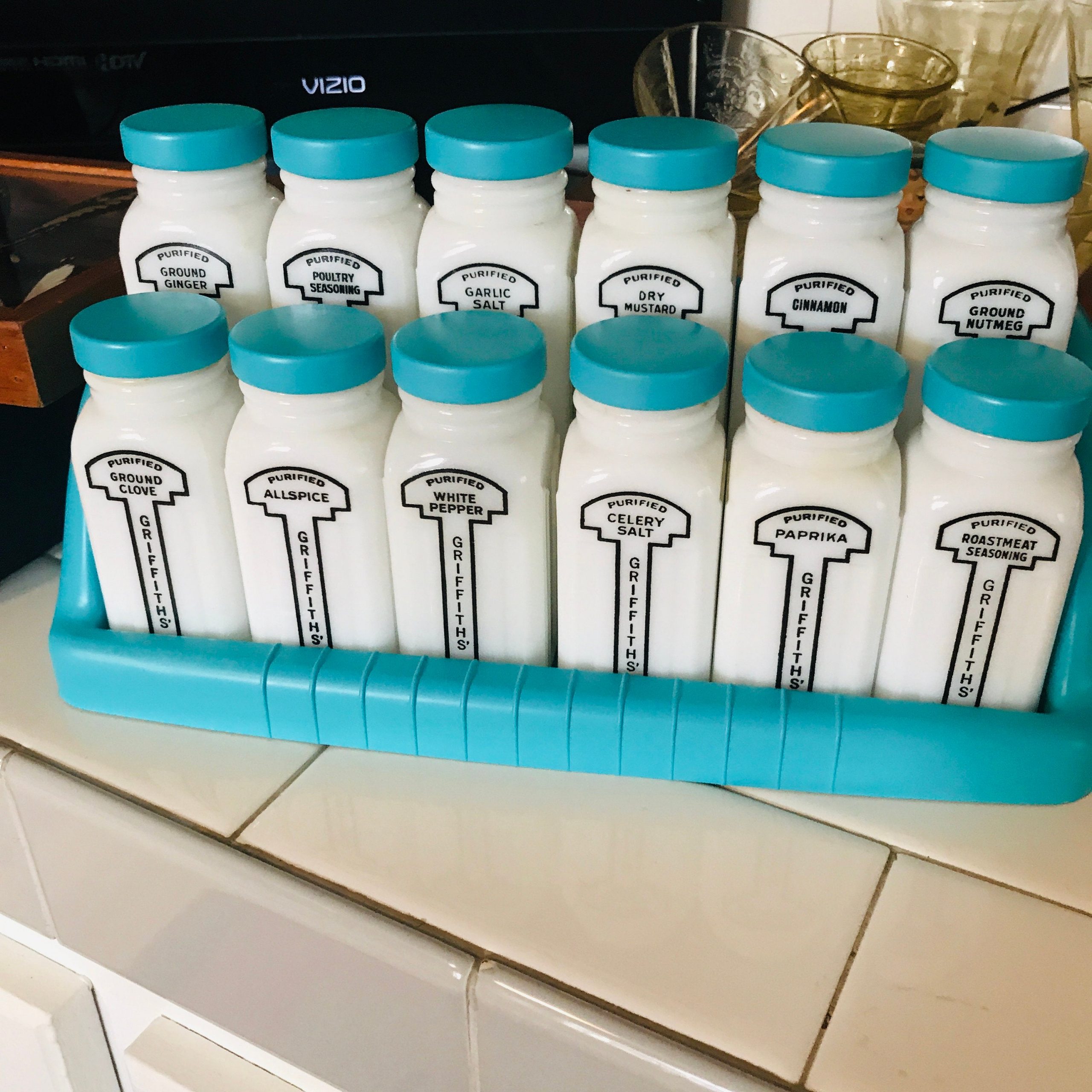https://www.truevintageantiques.com/wp-content/uploads/2020/06/vintage-1950s-milk-glass-spice-jars-spices-rack-with-12-large-griffiiths-aqua-blue-lids-rack-farmhouse-collectible-display-retro-kitchen-5ee0067b8-scaled.jpg