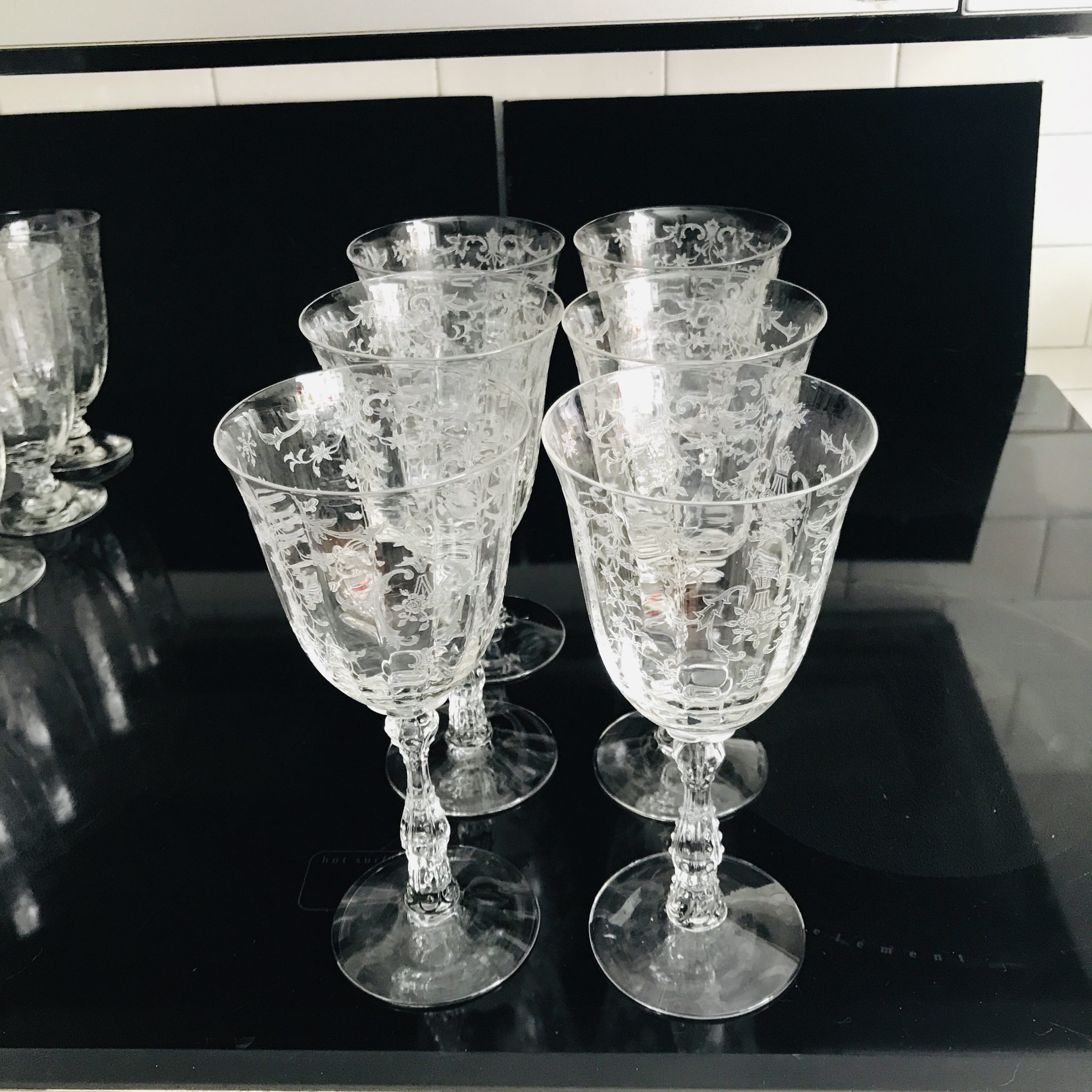https://www.truevintageantiques.com/wp-content/uploads/2020/06/vintage-6-claret-tall-wine-glasses-fostoria-crystal-navarre-pattern-paneled-and-etched-with-ornate-stem-5ee555315-scaled.jpg