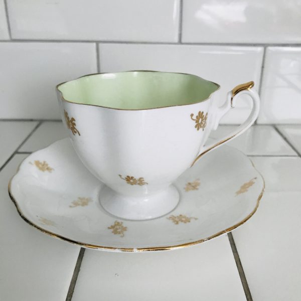 Queen Anne tea cup and saucer England Fine bone china Light green inside cup heavy gold floral pattern farmhouse collectible display