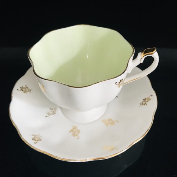 Queen Anne tea cup and saucer England Fine bone china Light green inside cup heavy gold floral pattern farmhouse collectible display