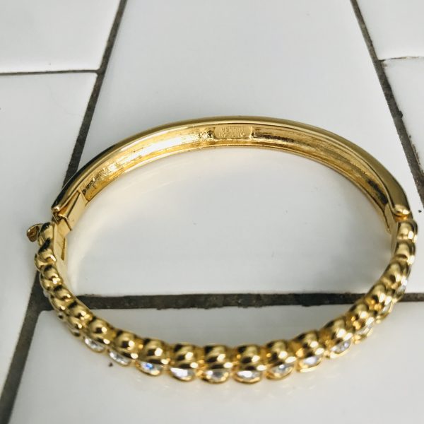 Vintage bracelet stunning Nolan Miller signed bangle individually set Crystals in gold tone metal with slide clasp  2 1/4" across