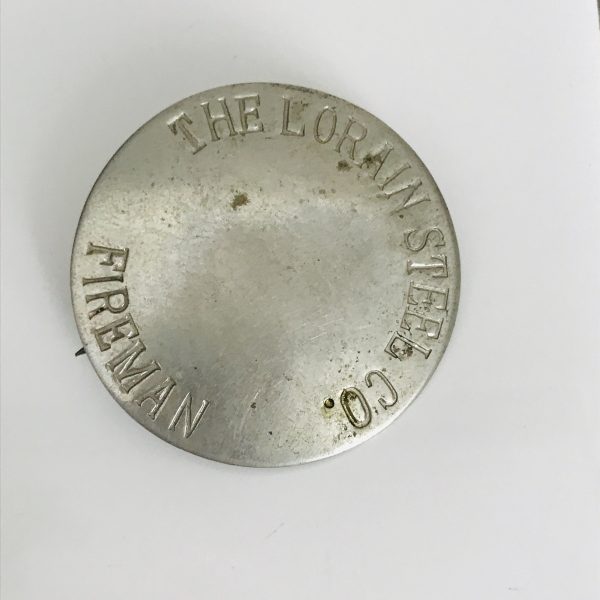 Vintage Lorain Steel Company Fireman badge silver tone metal 1940's Round maker Matthew's Brass C clasp