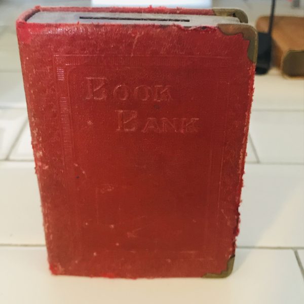 Vintage locking book bank made for storing money in a secret way metal with lock and leather binding Book Bank with money stacks raised