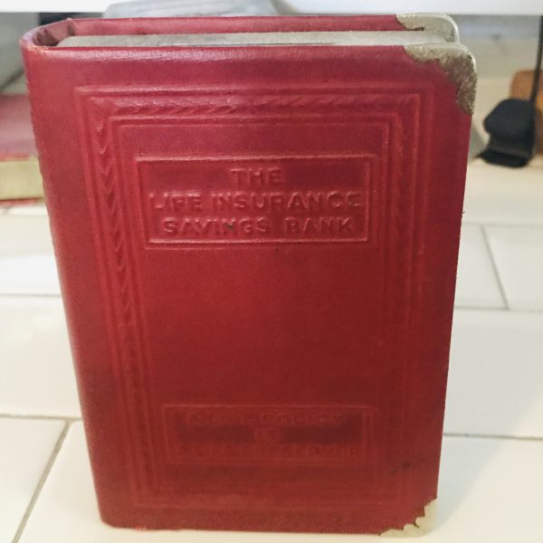 Vintage locking book bank made for storing money in a secret way metal with lock and leather binding The Life Insurance savings bank