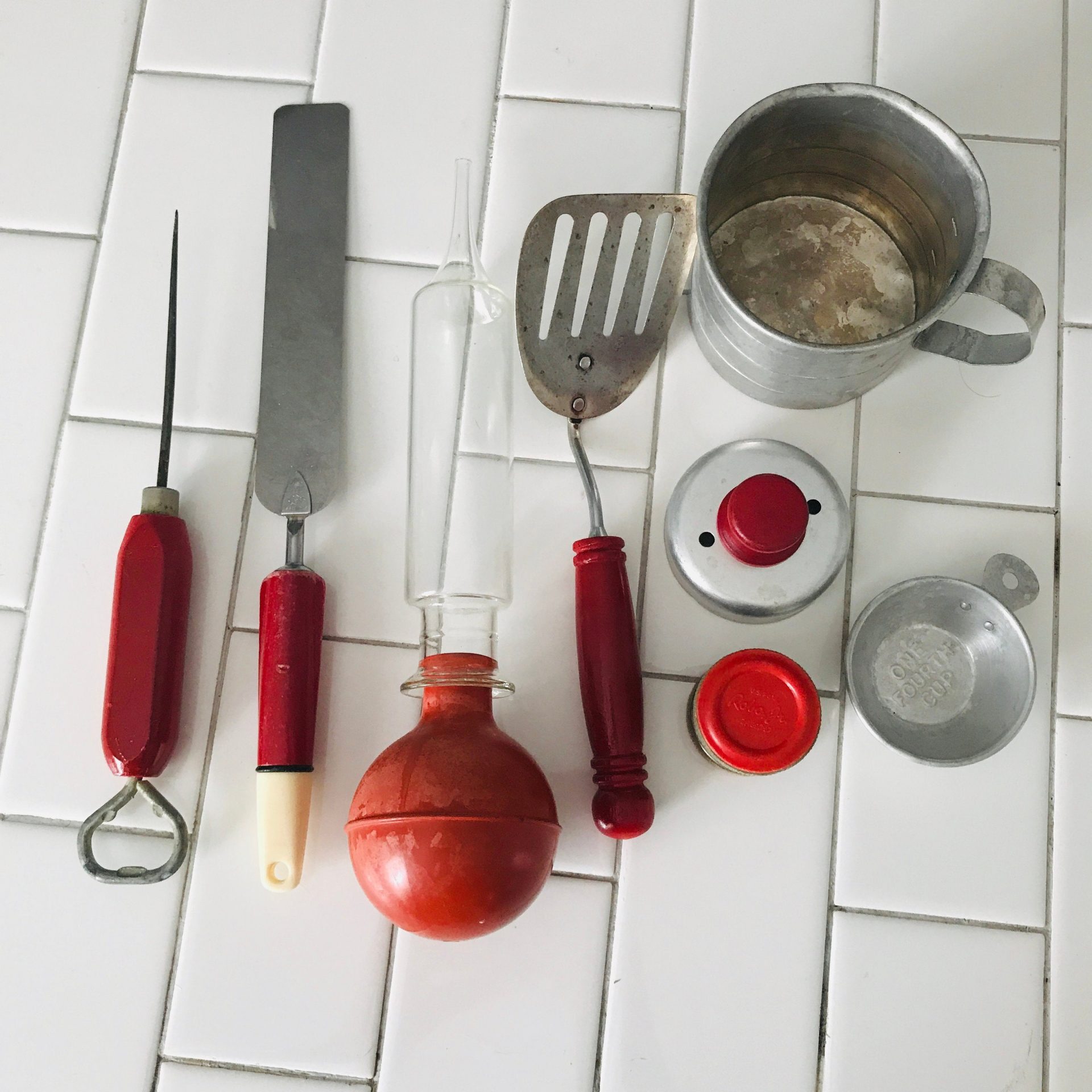 https://www.truevintageantiques.com/wp-content/uploads/2020/10/vintage-lot-of-kitchen-gadgets-mid-century-baster-spatula-measuring-cup-cookie-cutter-knife-sharpener-bottle-opener-ice-pick-5f823c8e2-scaled.jpg