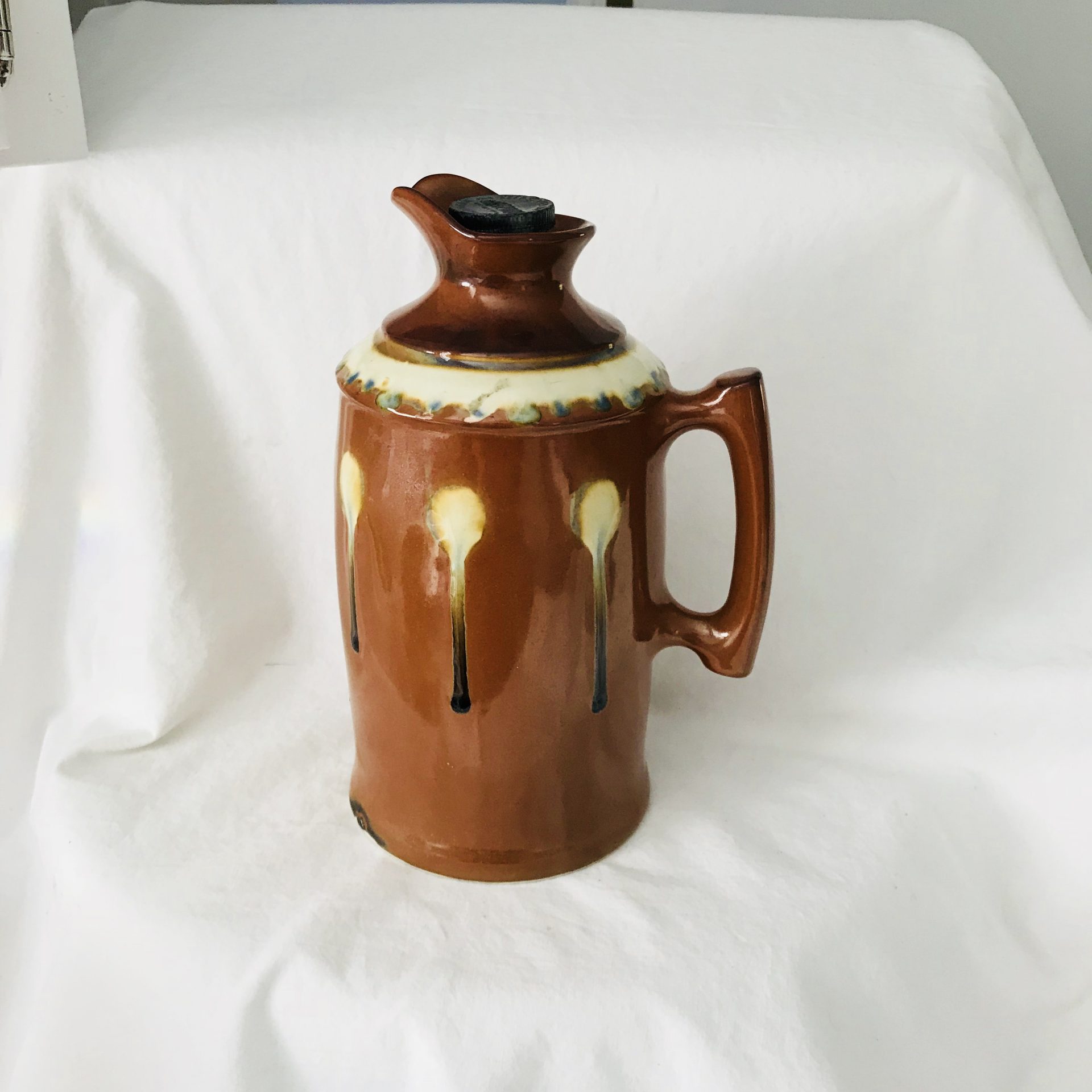 https://www.truevintageantiques.com/wp-content/uploads/2021/05/early-pottery-thermos-lined-warm-cold-drink-dispenser-storage-soup-water-glass-lined-with-thermos-cork-lid-blue-black-brown-pitcher-w-handle-60992f6e1-scaled.jpg