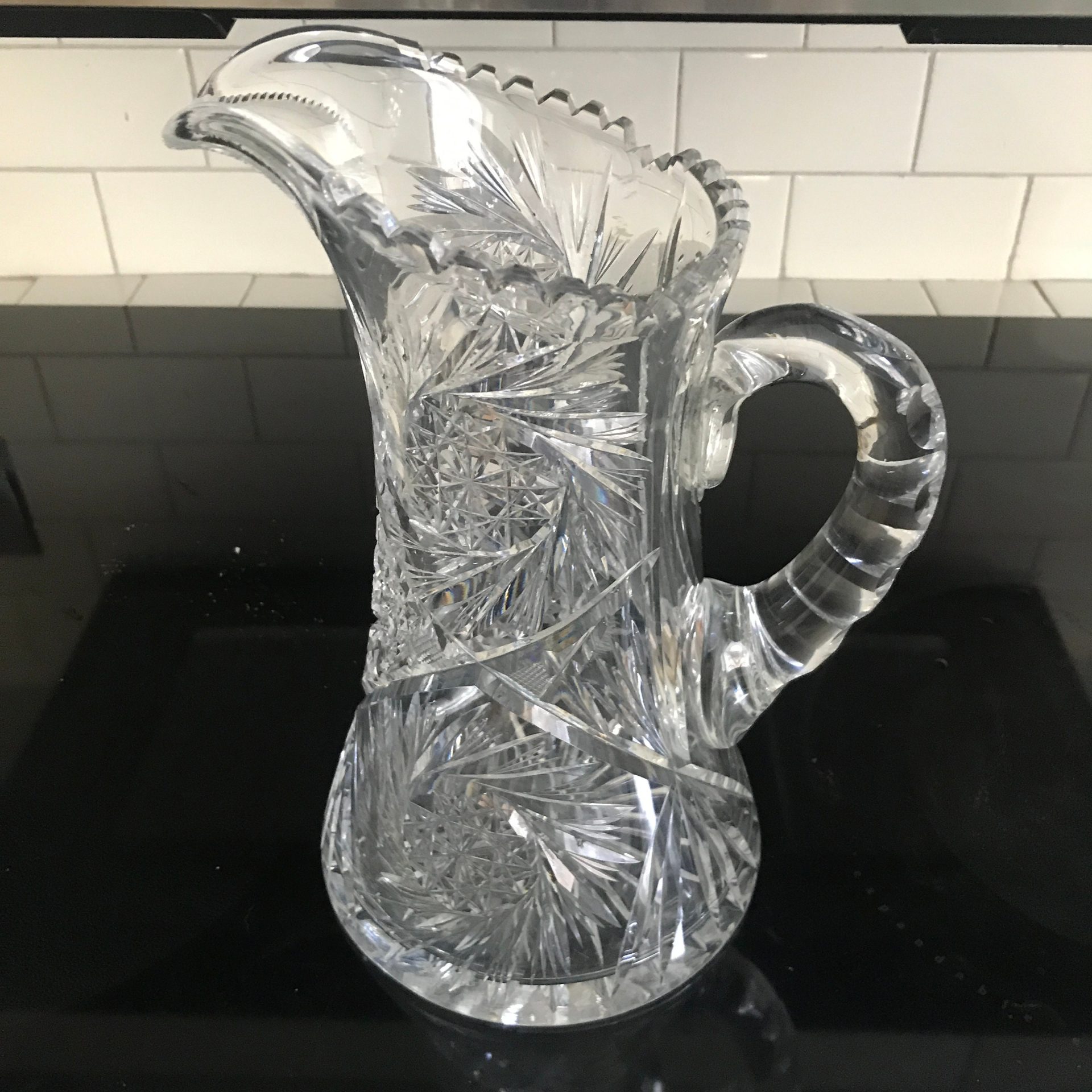 https://www.truevintageantiques.com/wp-content/uploads/2021/11/antique-american-brilliant-cut-glass-pitcher-beautiful-large-cut-rim-and-handle-mint-condition-11-tall-collectible-display-elegant-61a296ac1-scaled.jpg